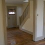 view of front porch entry door into living room from dining room