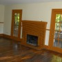 Fireplace and doors to side porch in living room