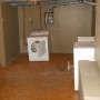 laundry machines in laundry room in basement