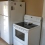 refrigerator and electric stove oven in kitchen