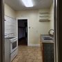 view into kitchen from side door entryway landing