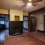 view of decorative fireplace in living room , and closet, and doorway to bedroom 2 from inside living room