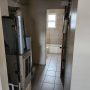 view of natural gas forced air furnace heater in utility room between bathroom and kitchen from kitchen