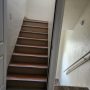 entry door view of apartment stairway upward, building hallway downward