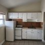 kitchen supplied with refrigerator and gas stove – oven view from living room